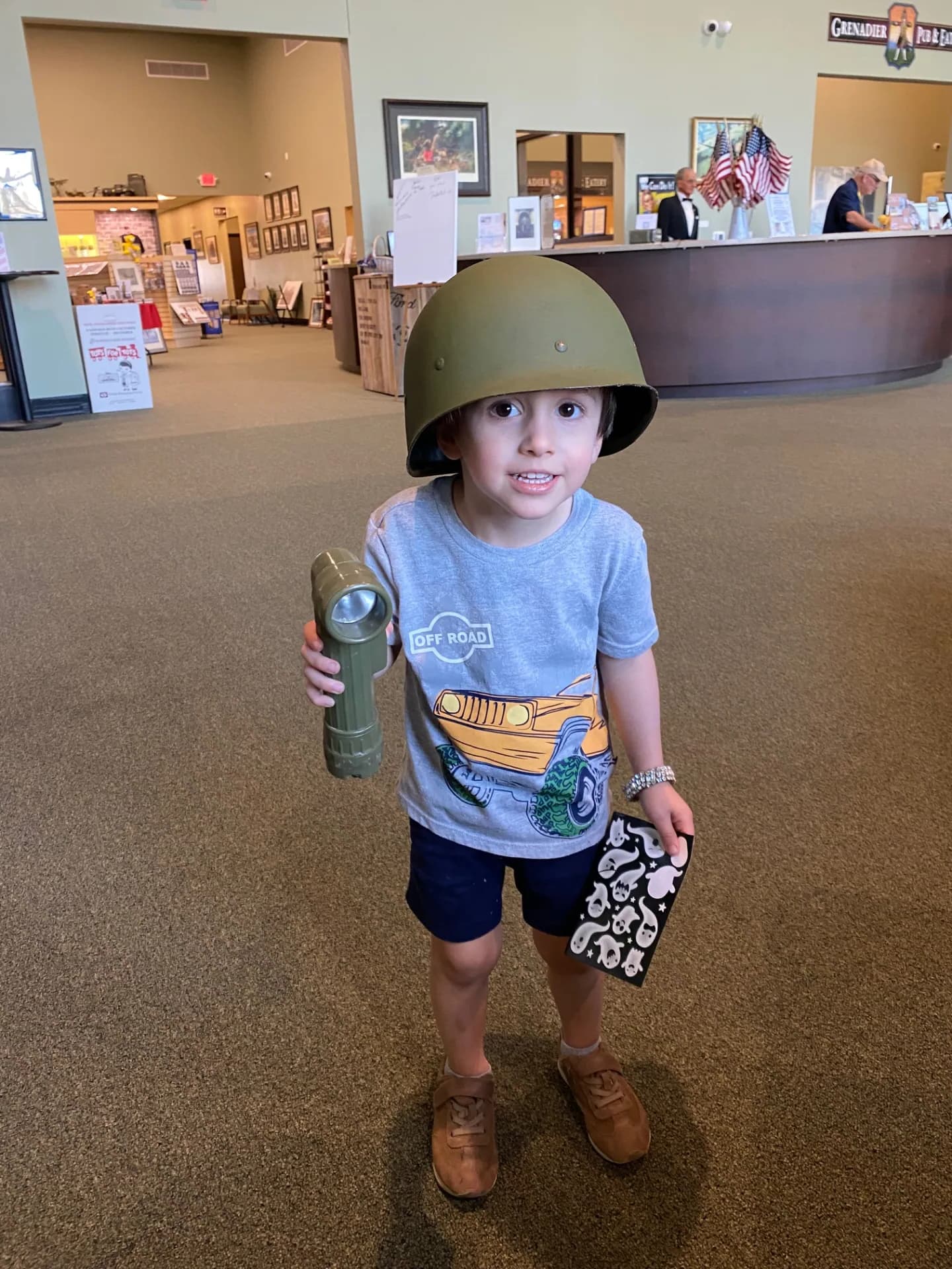 Young visitor trying on a WWII helmet at the museum