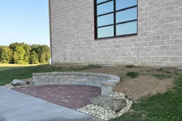 Curved seating wall and engraved brick paving in the Legacy Garden at the museum
